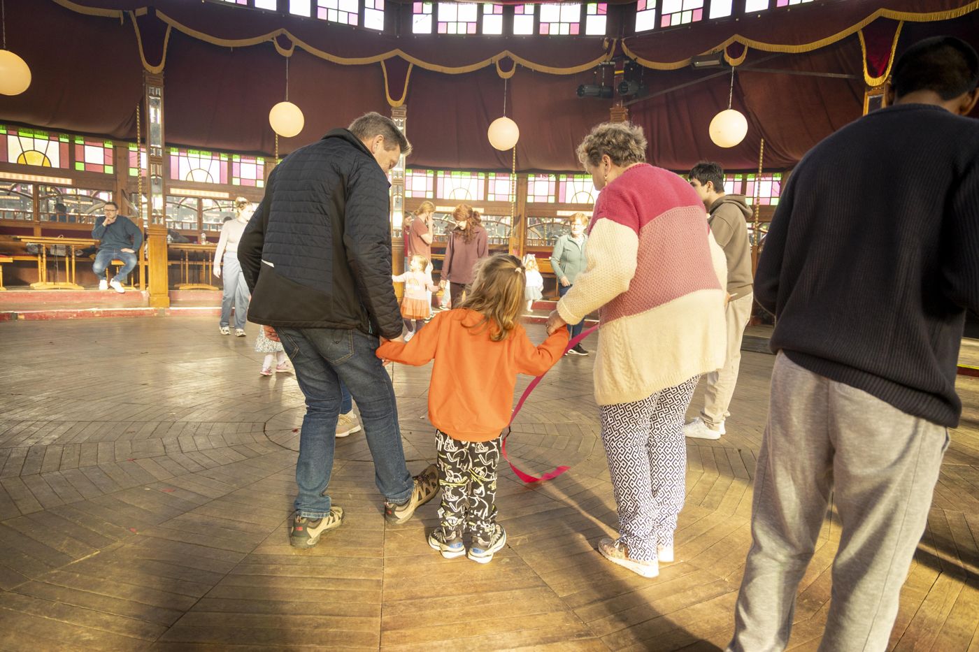 Families dancing together in the Spiegeltent